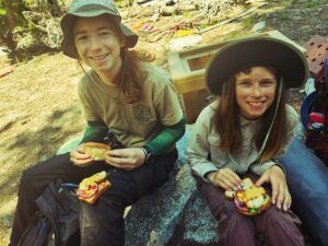 Oliver Bullwinkle (left) and Sylas Kauffmann (right) enjoy a fine backcountry meal during a volunteer work trip in the summer of 2024.